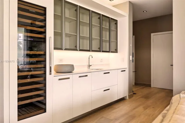 a kitchen with a refrigerator and a sink