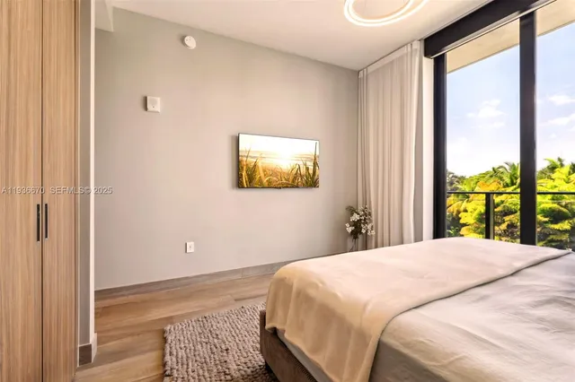 a bedroom with a bed and a large window