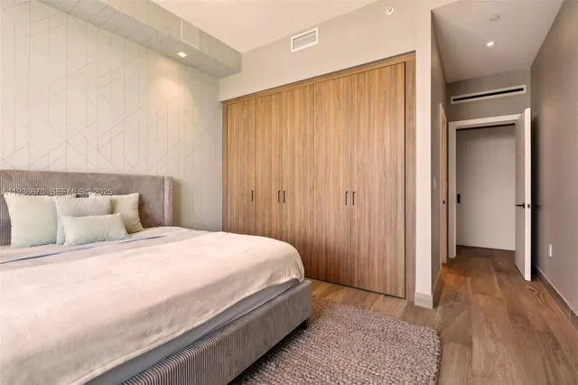 a bedroom with a bed and a mirror