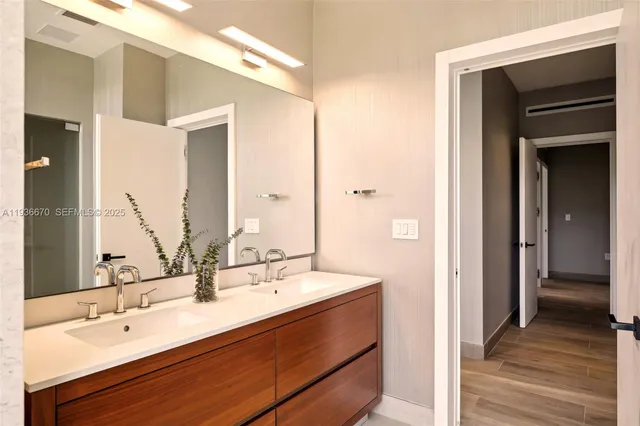 a bathroom with a double vanity sink and a mirror
