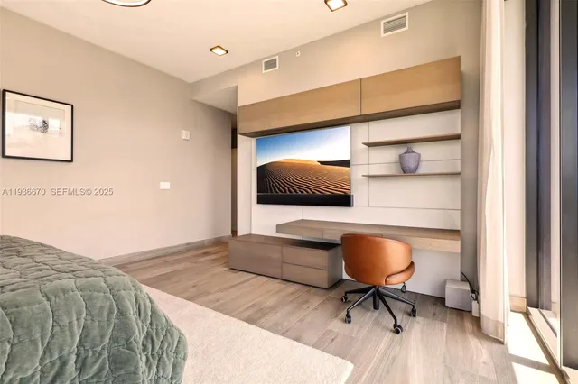 a bedroom with a bed and a desk