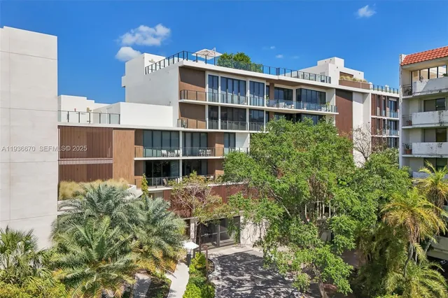 a front view of a building with a garden