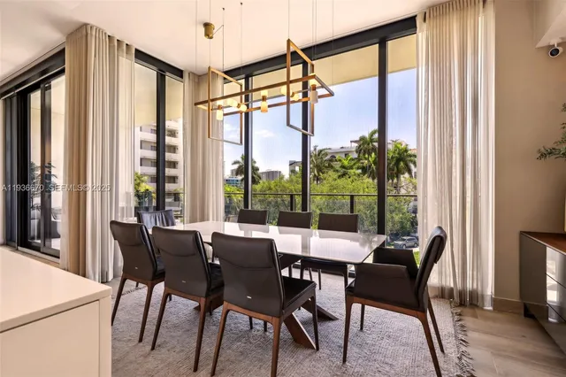 a dining room with furniture a chandelier and wooden floor