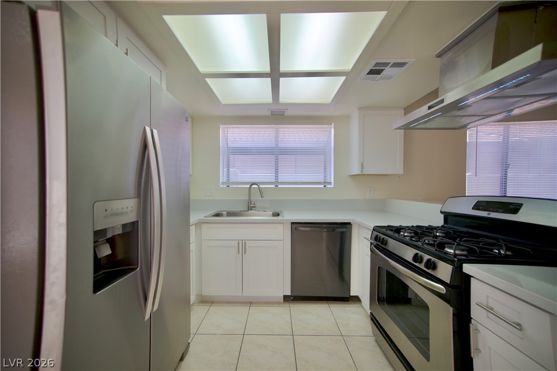 6501 Hartwood Road Las Vegas, NV 89108 - Photo 8 of 32 A well-lit kitchen with sleek stainless steel appliances awaits culinary endeavors.