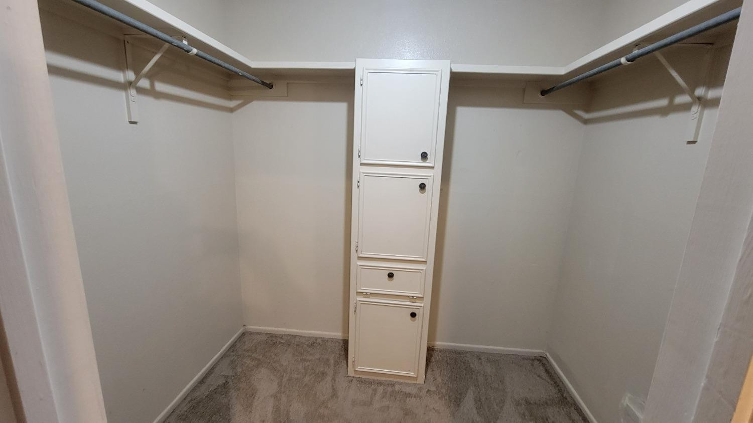 1107 80th Street, Unit B Lubbock, TX 79423 - Photo 12 of 12 a view of walk in closet with empty racks