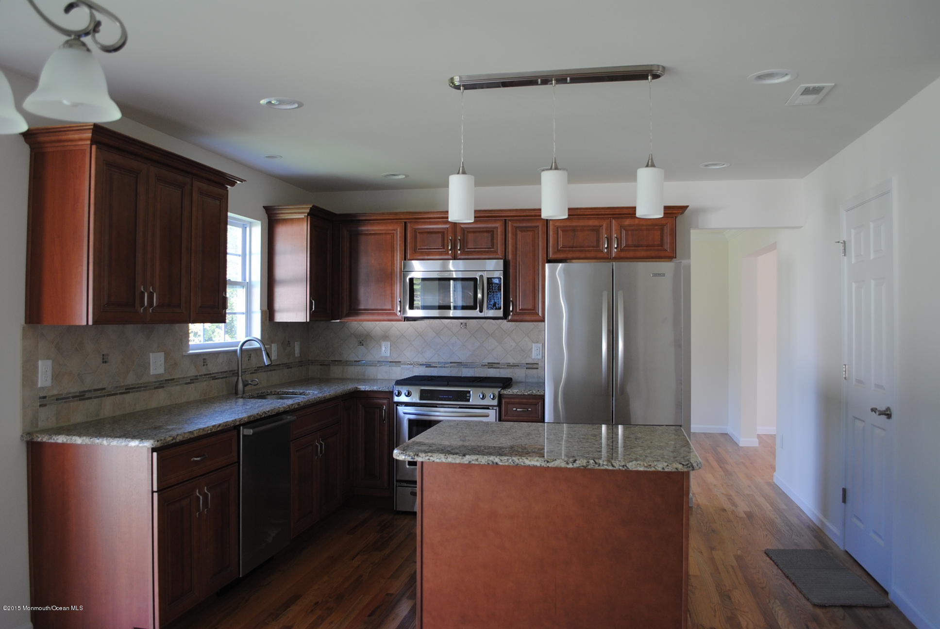 21 Bobstay Road Barnegat, NJ 08005 - Photo 9 of 17 a kitchen with stainless steel appliances granite countertop a refrigerator a sink dishwasher a stove and white countertops with wooden floor