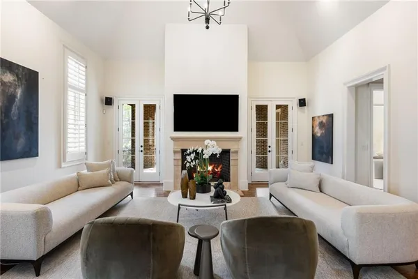a living room with furniture a fireplace and a flat screen tv