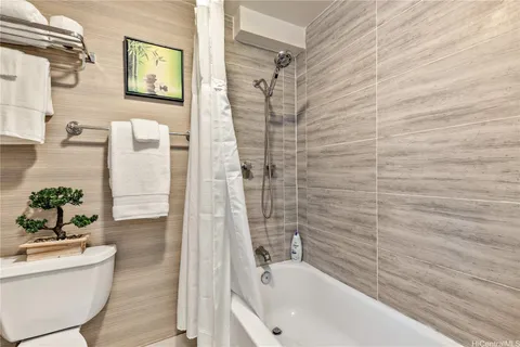 a bathroom with a bathtub and shower