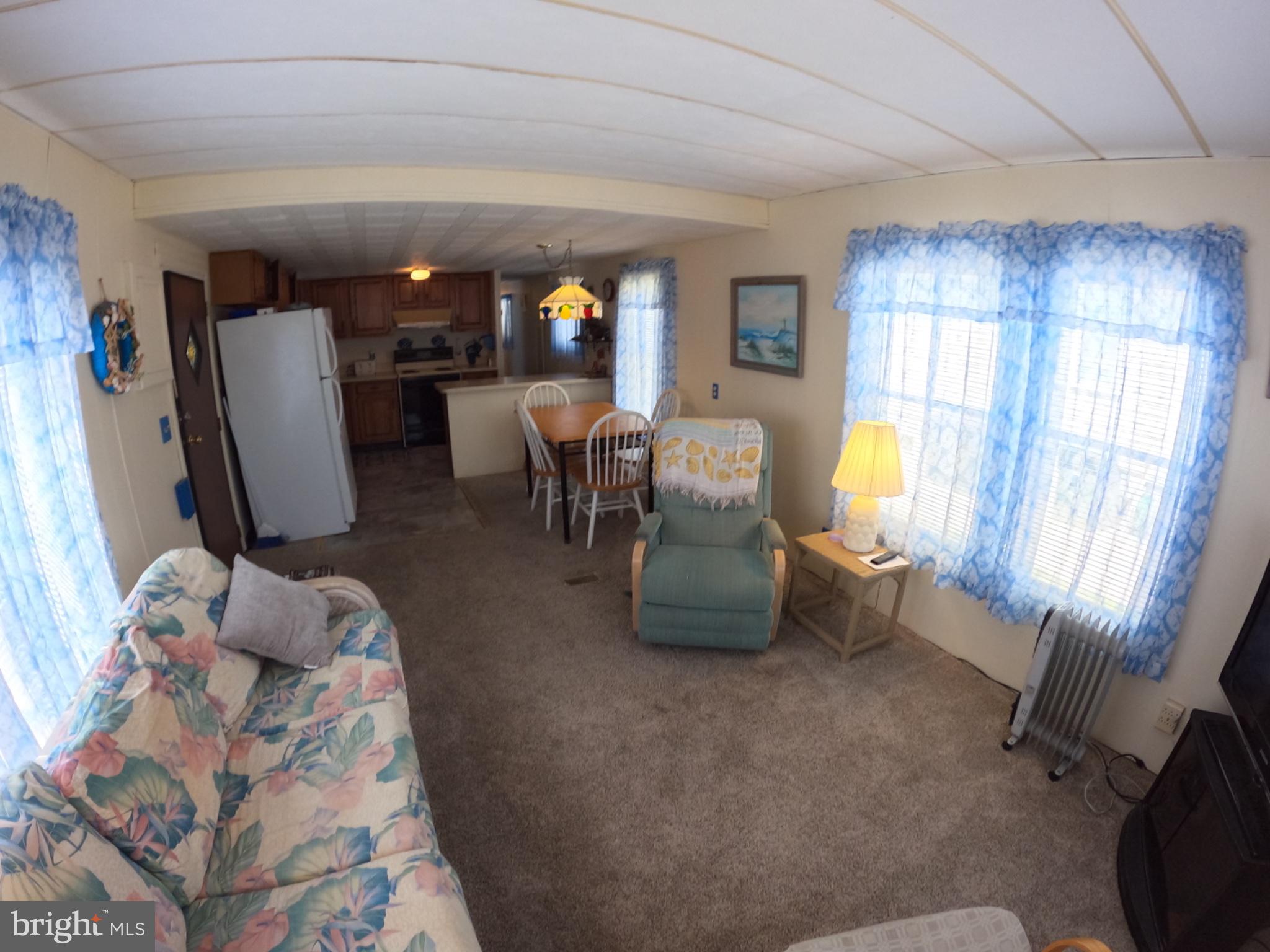 163 Clamshell Road Ocean City, MD 21842 - Photo 6 of 18 a view of a livingroom with furniture and a window