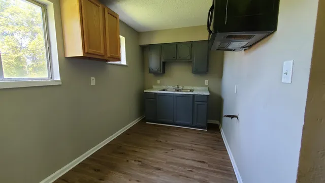 a view of storage and utility room with wooden floor