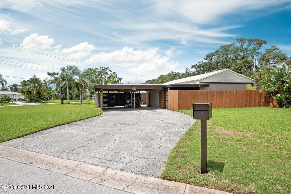 907 Santa Cruz Road Cocoa Beach, FL 32931 - Photo 2 of 30 a front view of house with yard and green space