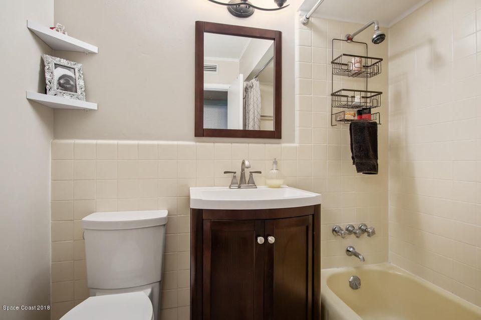907 Santa Cruz Road Cocoa Beach, FL 32931 - Photo 12 of 30 a bathroom with a sink a toilet and shower