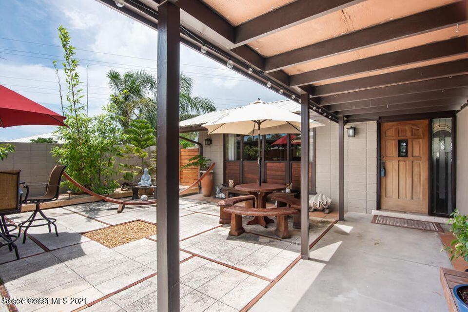907 Santa Cruz Road Cocoa Beach, FL 32931 - Photo 14 of 30 a view of a dinning table and chairs in patio