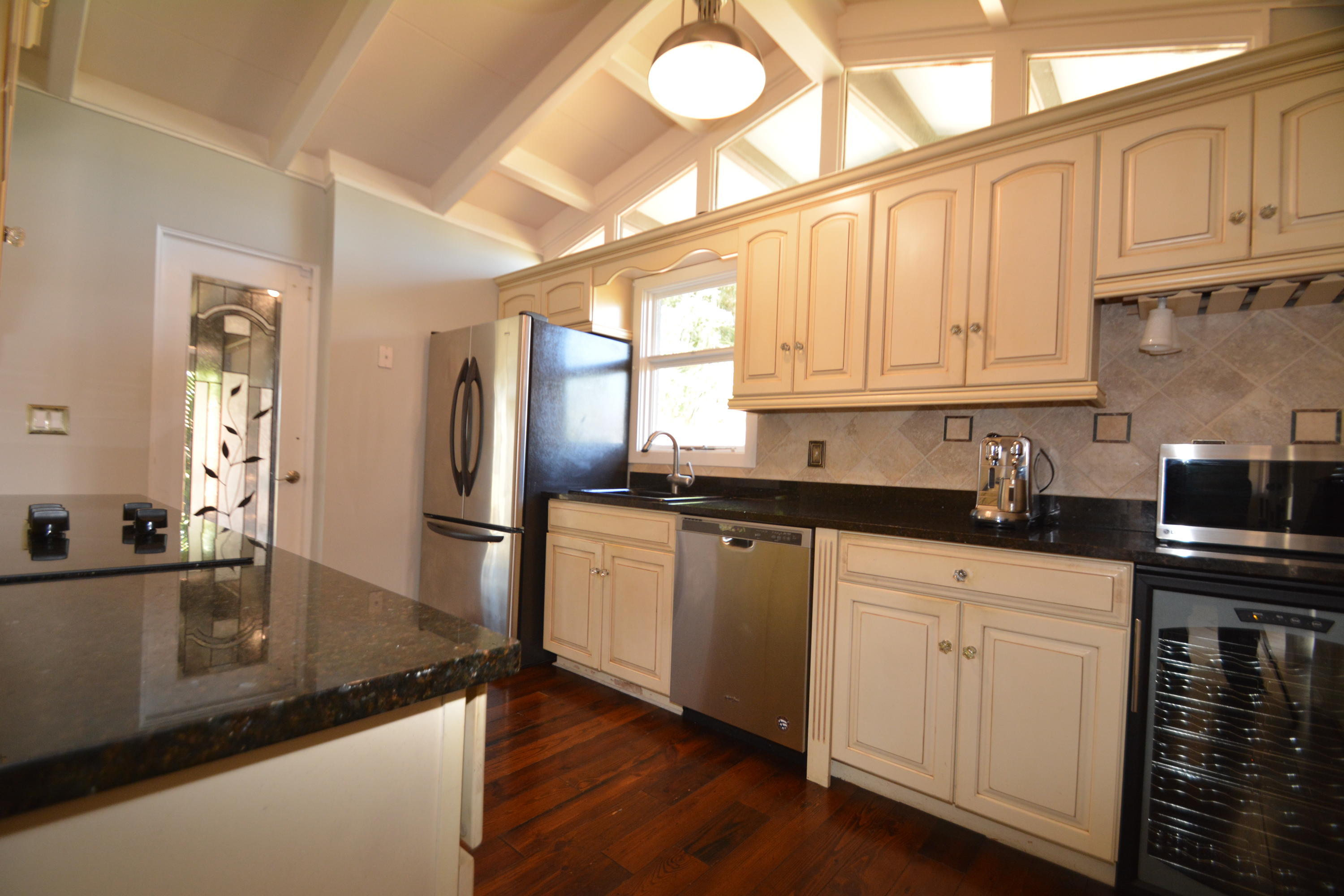 907 Santa Cruz Road Cocoa Beach, FL 32931 - Photo 20 of 30 a kitchen with stainless steel appliances granite countertop a sink a stove and cabinets
