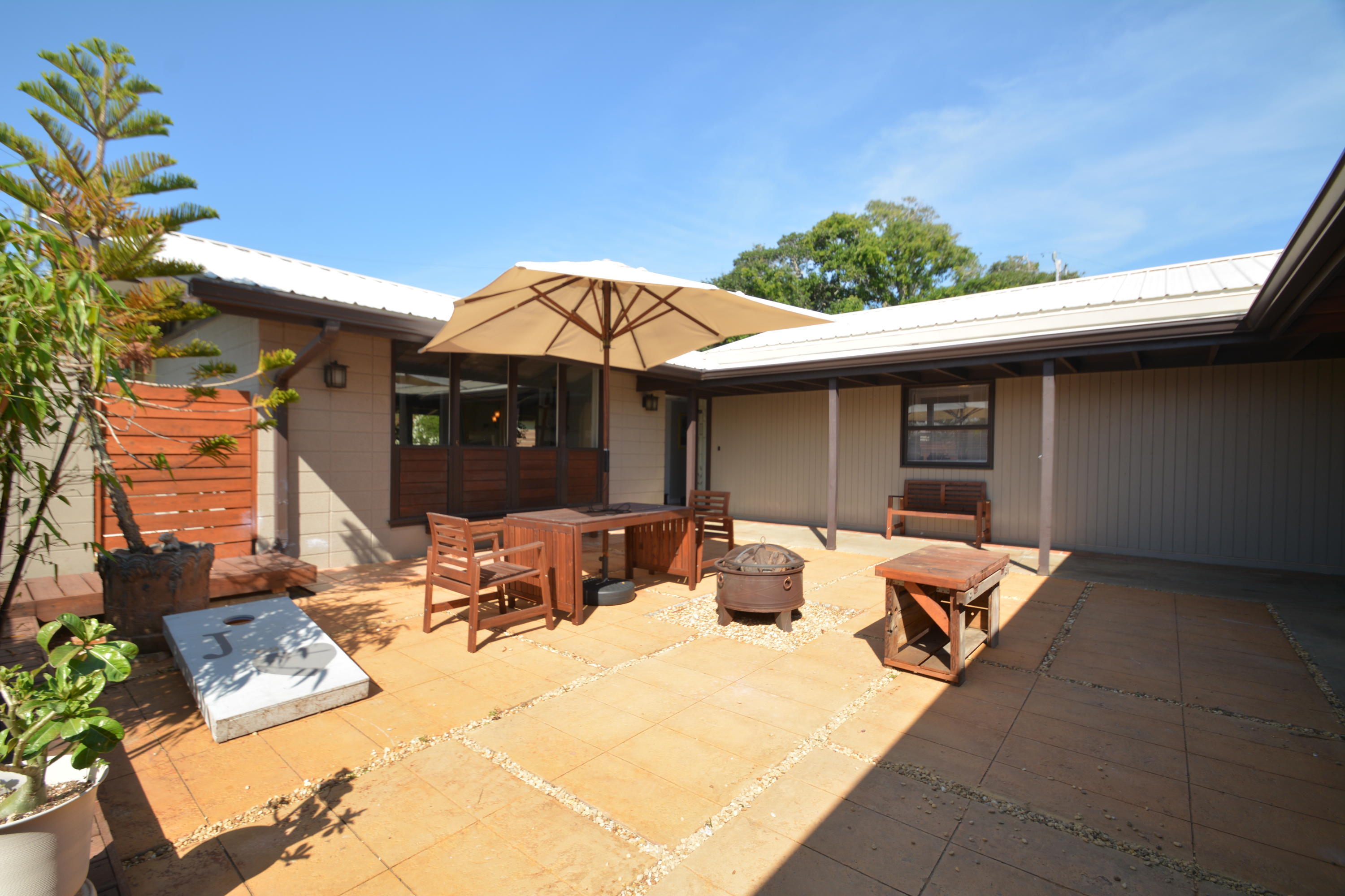 907 Santa Cruz Road Cocoa Beach, FL 32931 - Photo 21 of 30 a view of a patio with table and chairs under an umbrella