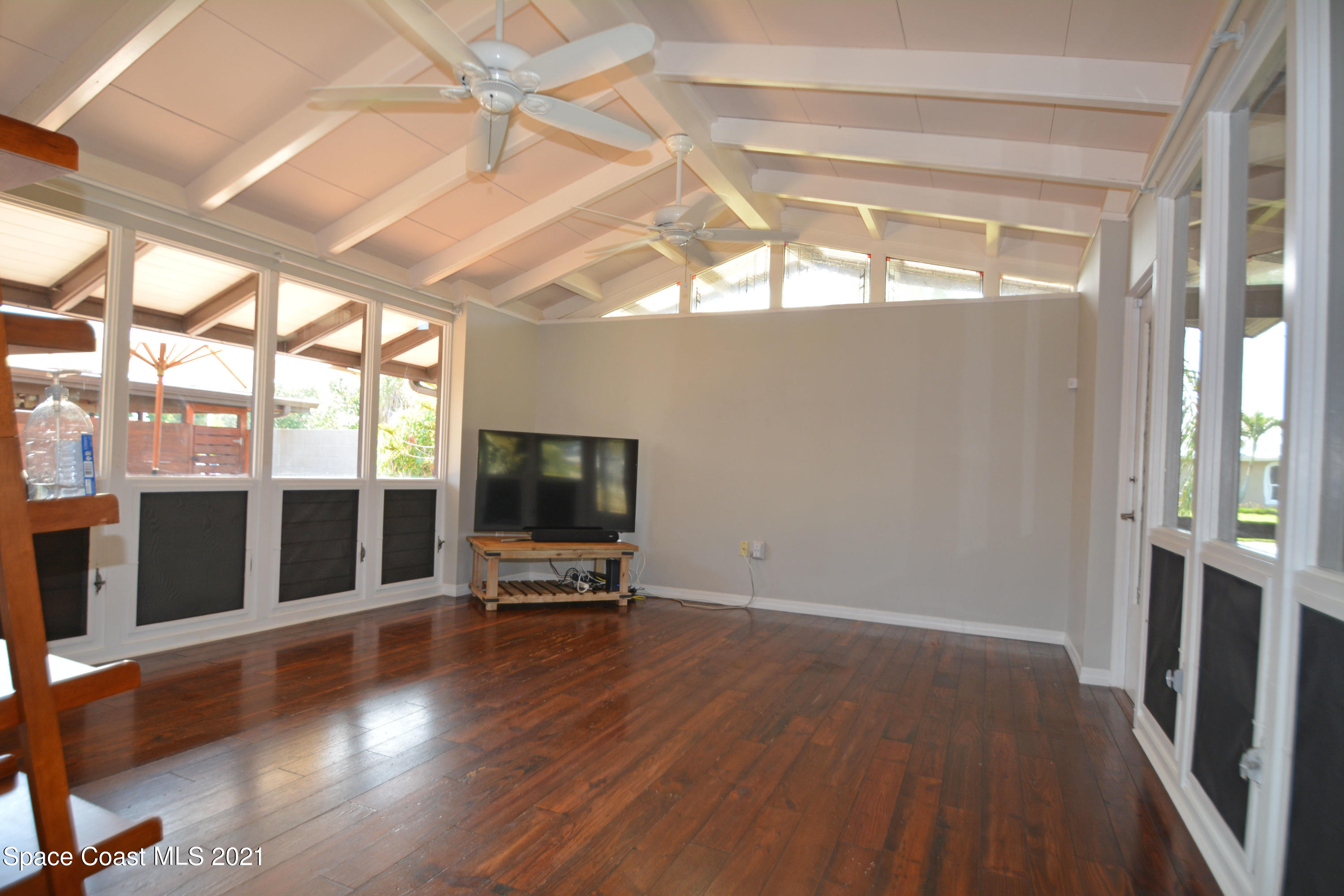 907 Santa Cruz Road Cocoa Beach, FL 32931 - Photo 8 of 30 a view of a livingroom with wooden floor and a window