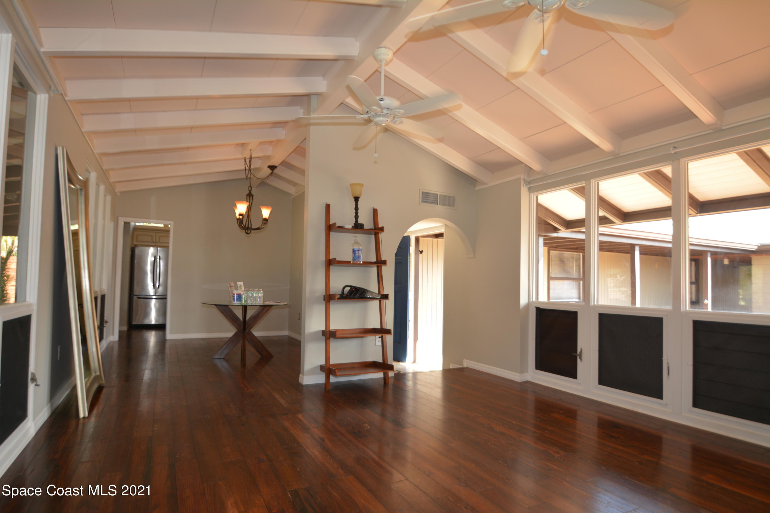 907 Santa Cruz Road Cocoa Beach, FL 32931 - Photo 9 of 30 a view of empty room with wooden floor and fan