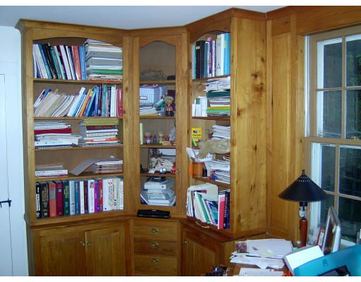 160 Dudleyville Road Leverett, MA 01054 - Photo 7 of 8 a living room with lots of books and a book shelf