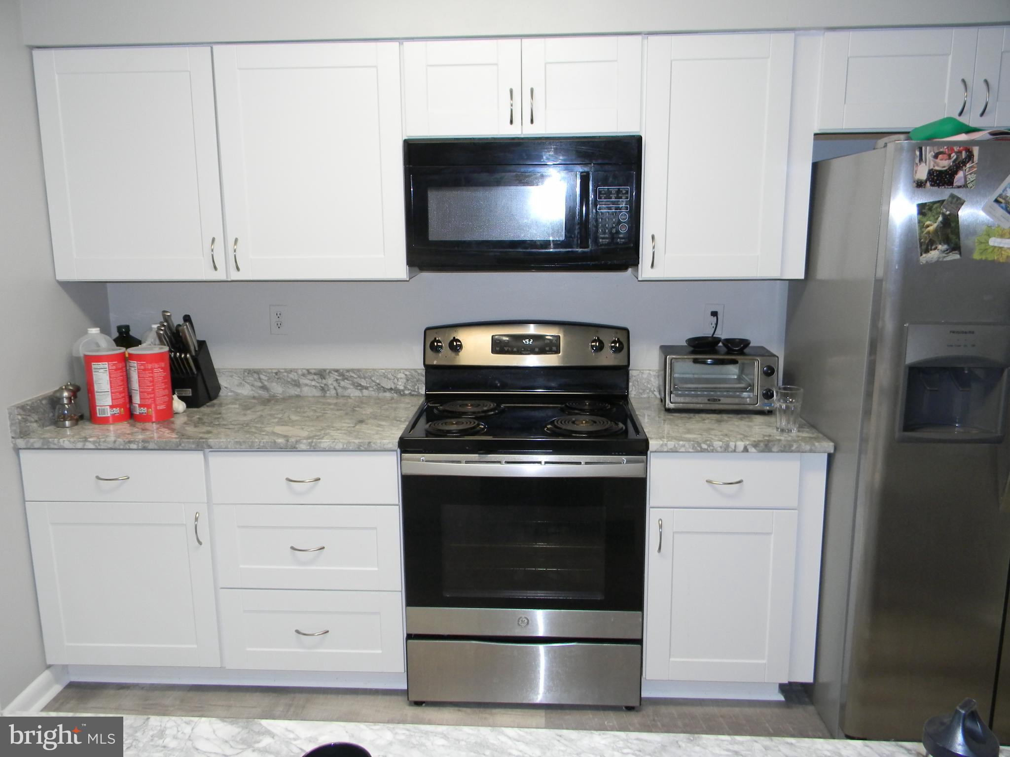 11319 Headlands Court Reston, VA 20191 - Photo 8 of 21 a kitchen with granite countertop white cabinets stainless steel appliances and sink