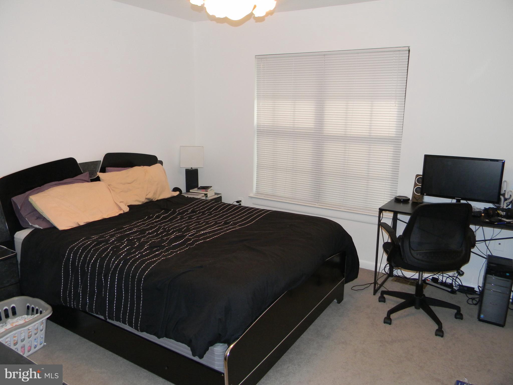 11319 Headlands Court Reston, VA 20191 - Photo 9 of 21 a bedroom with a bed and a window