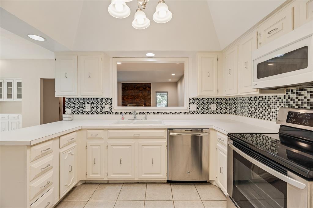 4988 Thunder Road Dallas, TX 75244 - Photo 7 of 32 Bright kitchen with white cabinetry and countertops