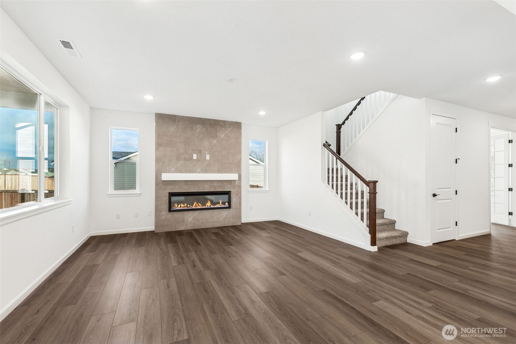 311 Crested Butte Boulevard, Unit 47 Mount Vernon, WA 98273 - Photo 4 of 13 wooden floor in an empty room with a window and wooden floor