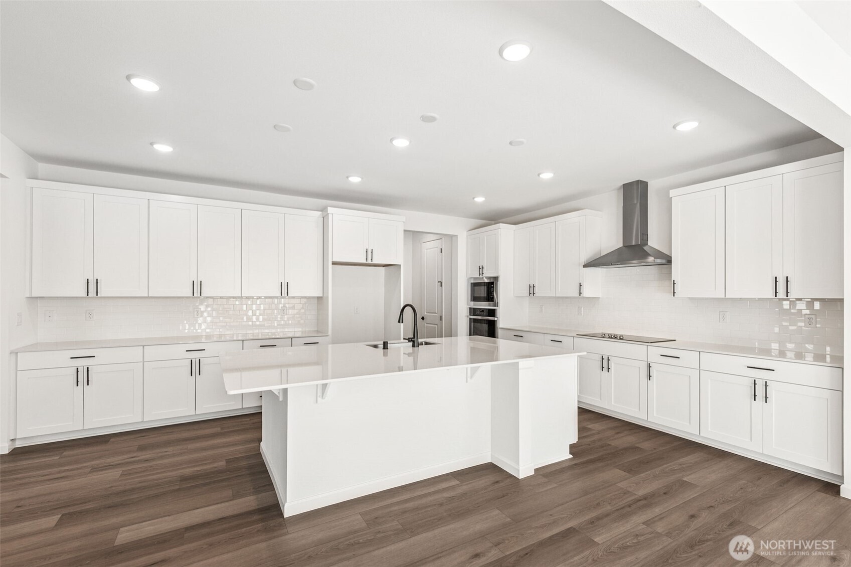 311 Crested Butte Boulevard, Unit 47 Mount Vernon, WA 98273 - Photo 6 of 13 a large kitchen with cabinets and wooden floor