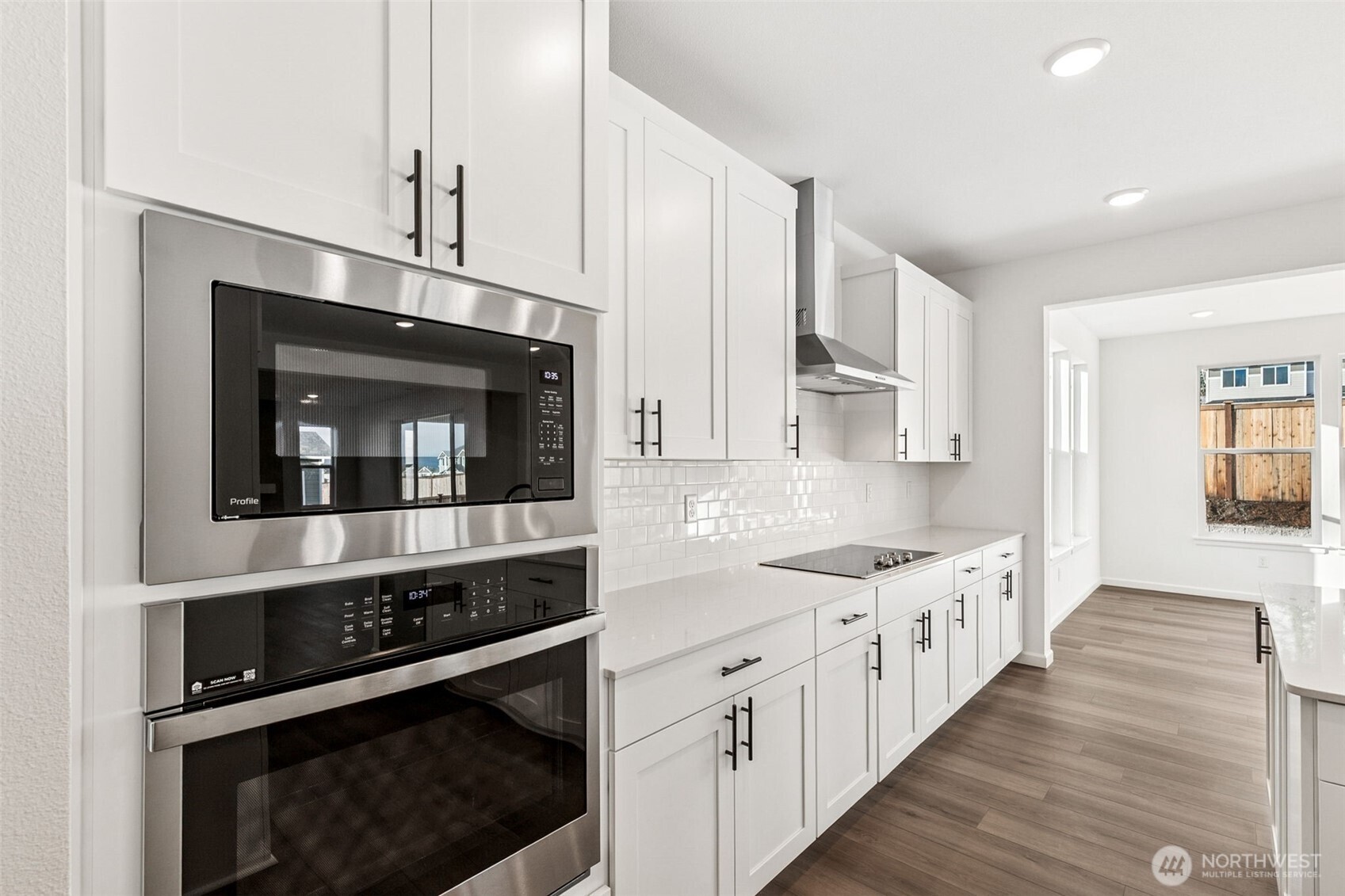 311 Crested Butte Boulevard, Unit 47 Mount Vernon, WA 98273 - Photo 7 of 13 a kitchen with stainless steel appliances a stove microwave and cabinets