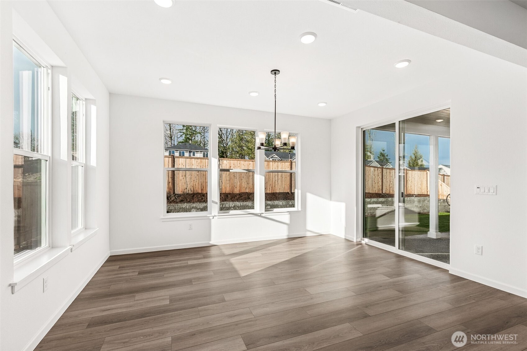 311 Crested Butte Boulevard, Unit 47 Mount Vernon, WA 98273 - Photo 8 of 13 a view of an empty room with wooden floor and a window