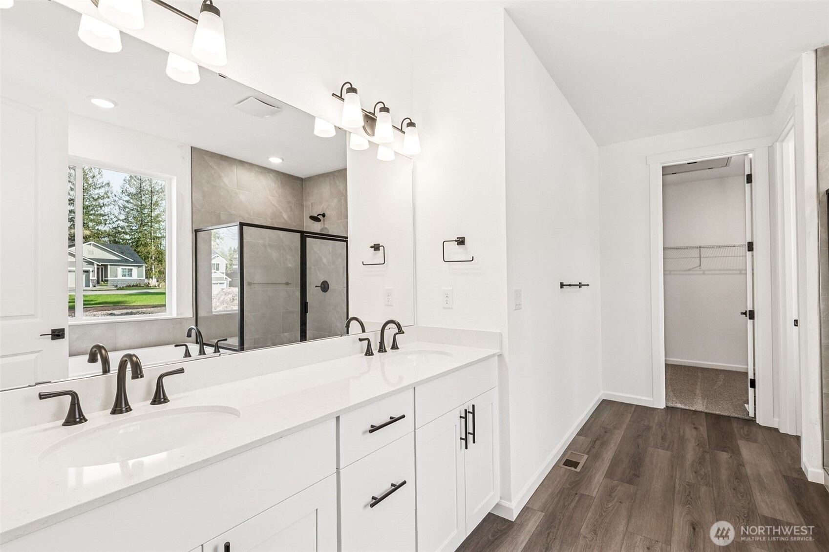 311 Crested Butte Boulevard, Unit 47 Mount Vernon, WA 98273 - Photo 9 of 13 a bathroom with a double vanity sink mirror and shower