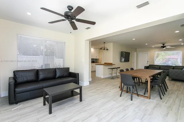 a living room with furniture and a wooden floor