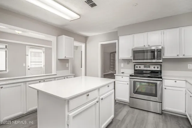 a kitchen with a stove oven and sink
