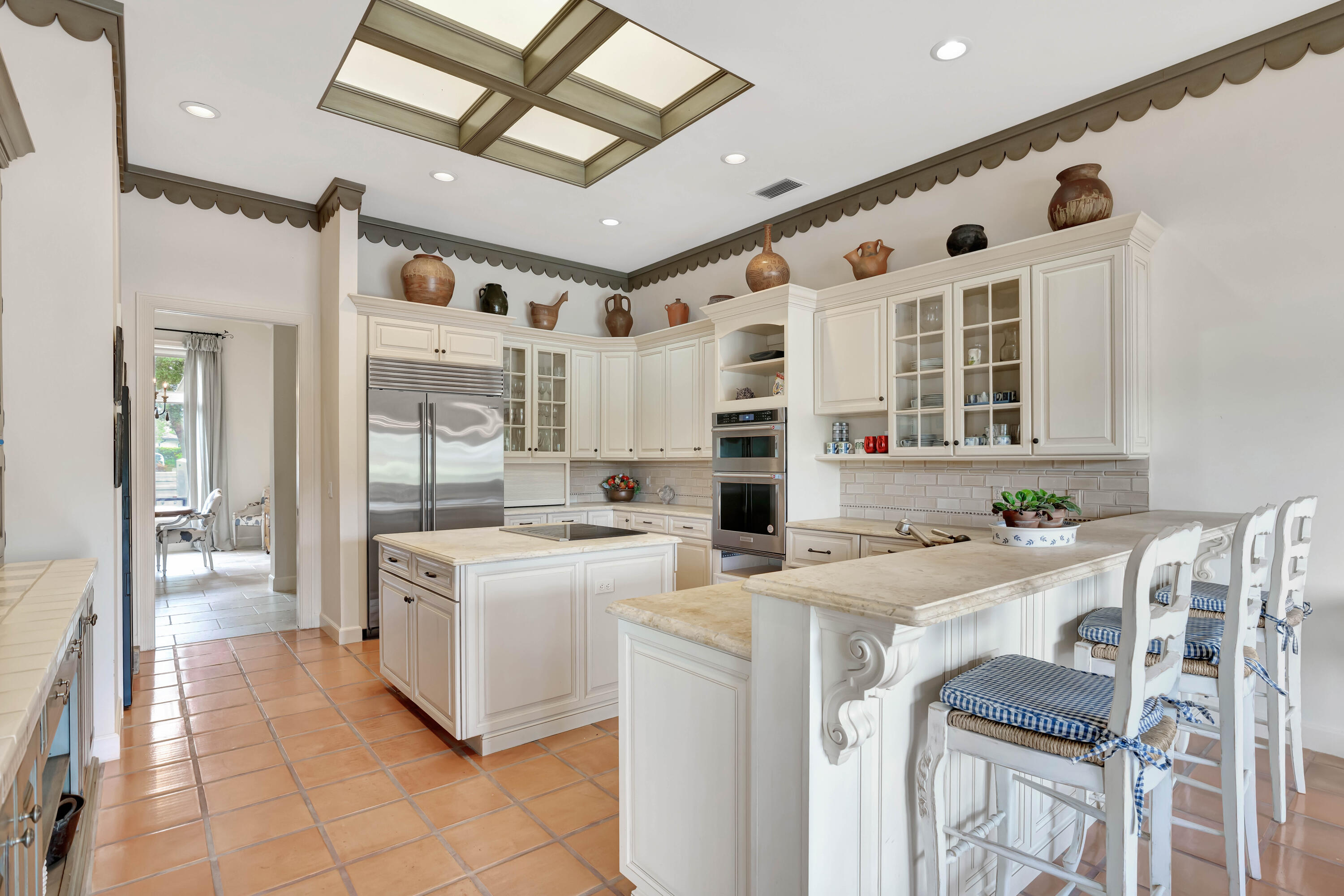 266 Locha Drive Jupiter, FL 33458 - Photo 13 of 60 a large white kitchen with a stove a sink dishwasher and a refrigerator with wooden floor