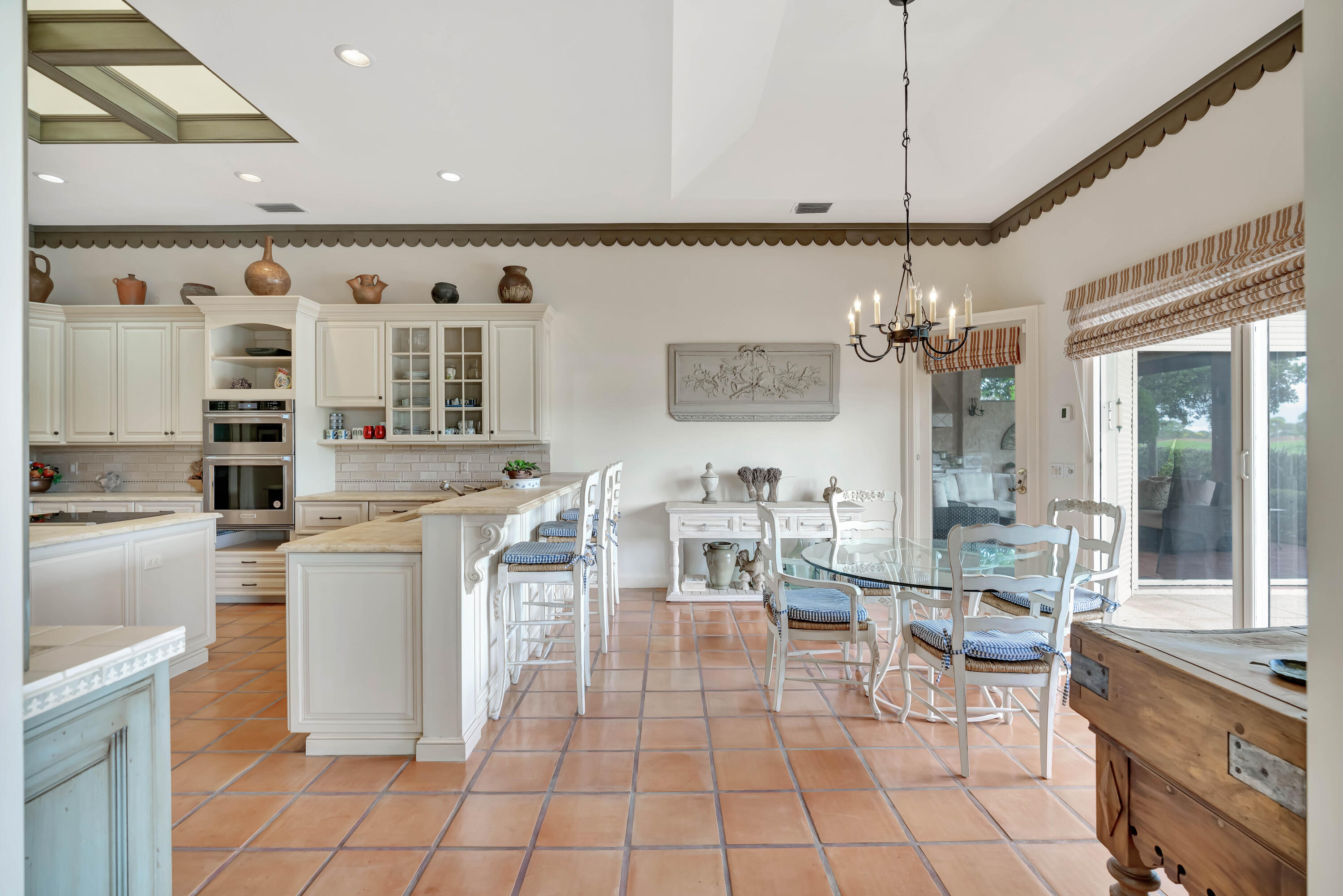 266 Locha Drive Jupiter, FL 33458 - Photo 15 of 60 a kitchen with stainless steel appliances a table and chairs in it