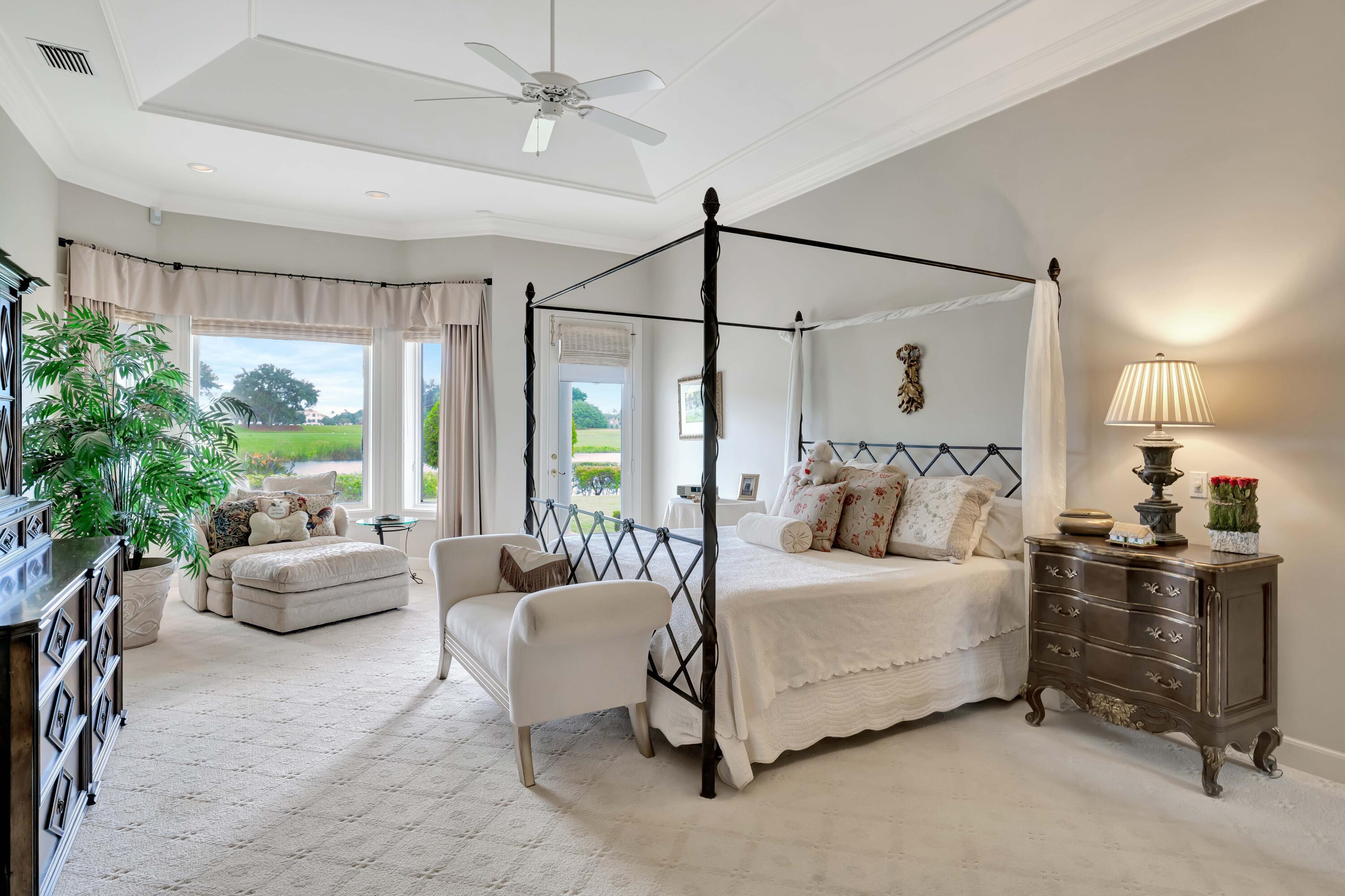 266 Locha Drive Jupiter, FL 33458 - Photo 18 of 60 a bedroom with a bed couch and a window