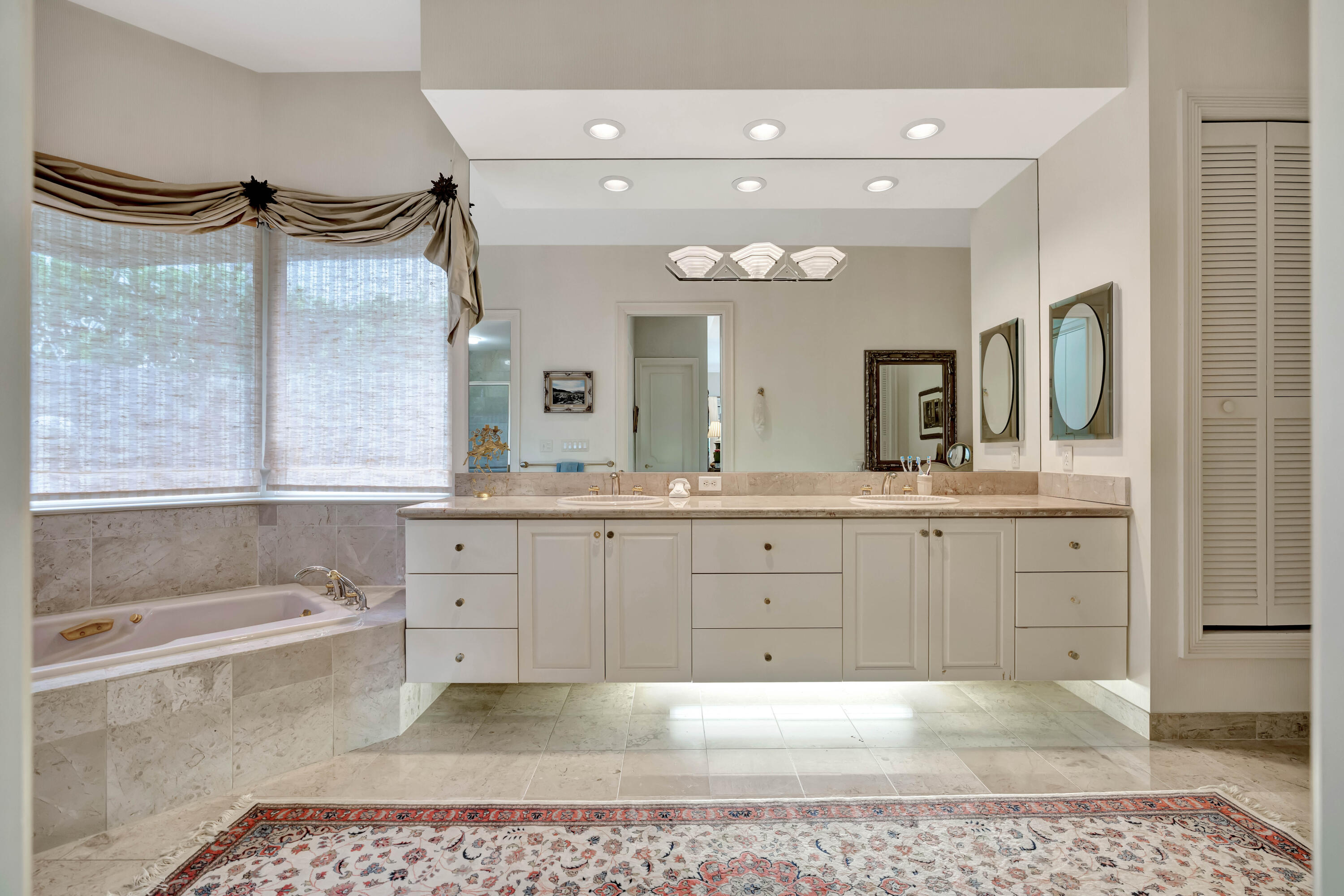 266 Locha Drive Jupiter, FL 33458 - Photo 21 of 60 a spacious bathroom with a granite countertop sink mirror and bathtub