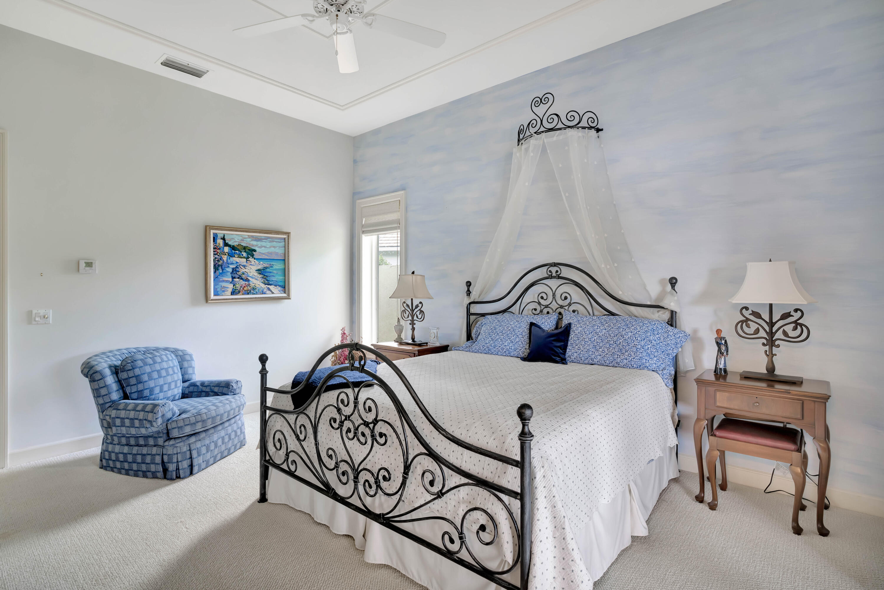 266 Locha Drive Jupiter, FL 33458 - Photo 31 of 60 a bedroom with a bed a couch and a chandelier