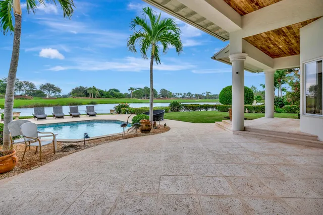 a view of a swimming pool and a couches in a patio