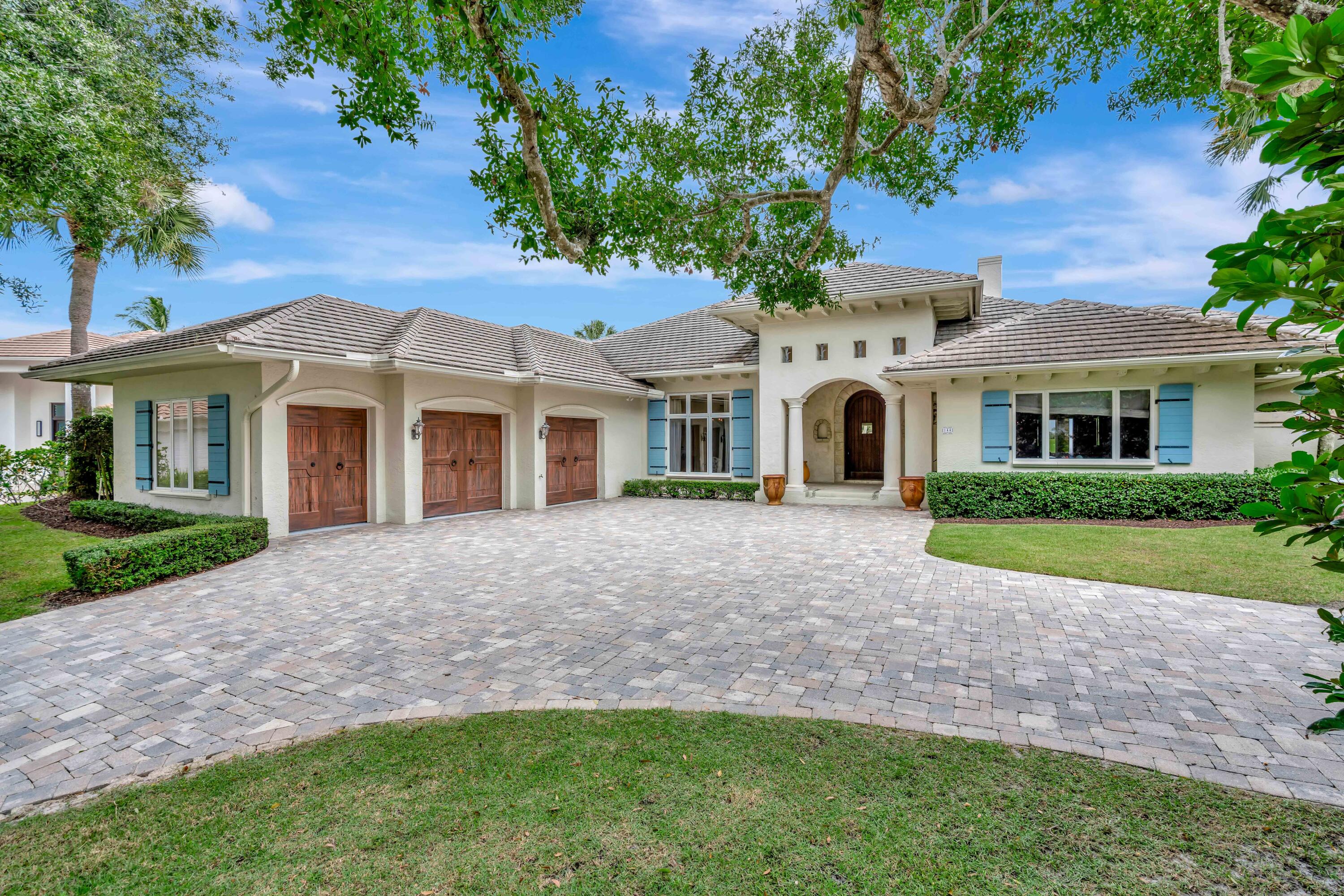 266 Locha Drive Jupiter, FL 33458 - Photo 4 of 60 front view of a house with a yard