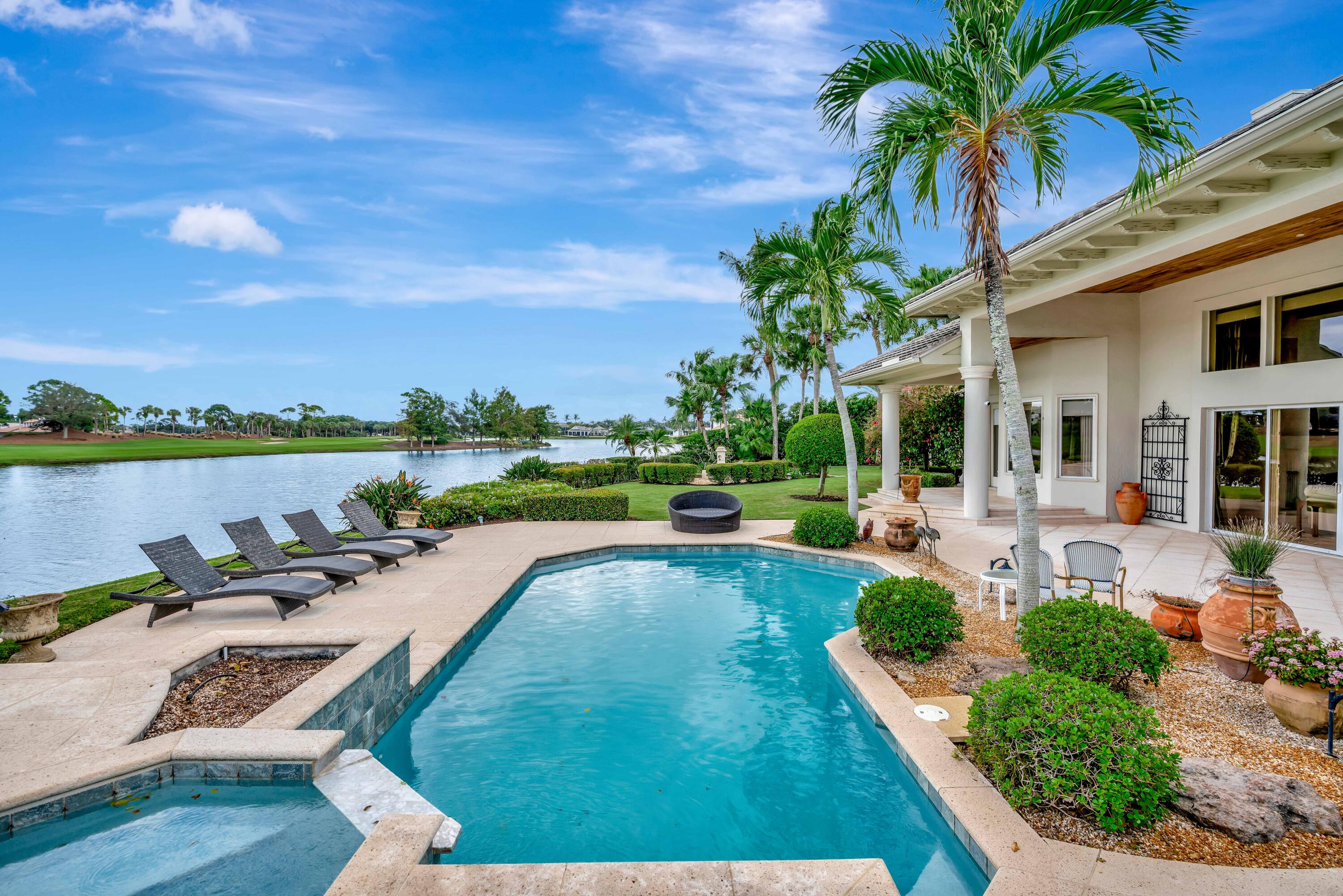 266 Locha Drive Jupiter, FL 33458 - Photo 46 of 60 a view of swimming pool with outdoor seating and plants