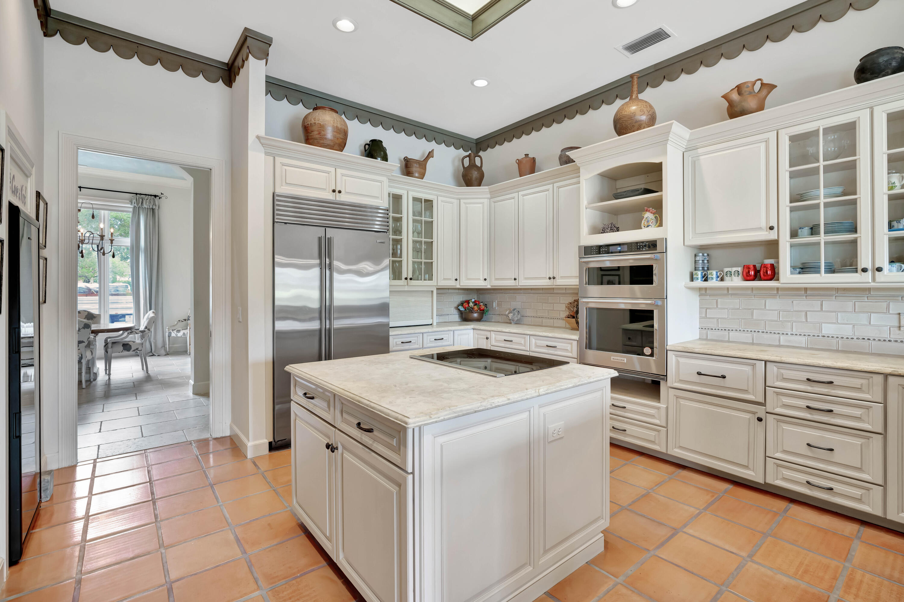 266 Locha Drive Jupiter, FL 33458 - Photo 10 of 60 a kitchen with white cabinets and white appliances