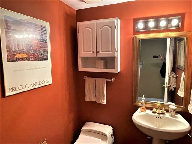a bathroom with a toilet sink and mirror