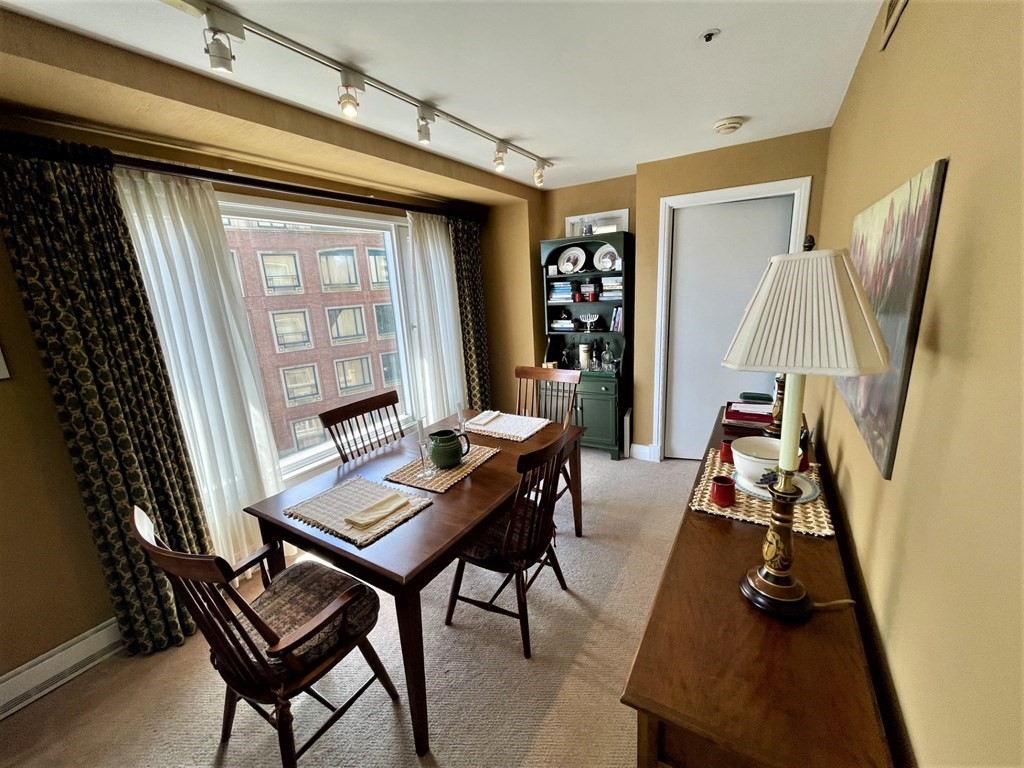 20 Rowes Wharf, Unit 604 Boston, MA 02110 - Photo 3 of 20 a view of a workspace with furniture and a window