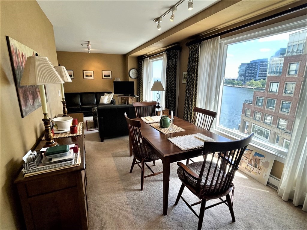 20 Rowes Wharf, Unit 604 Boston, MA 02110 - Photo 4 of 20 a view of a dining room with furniture window and wooden floor