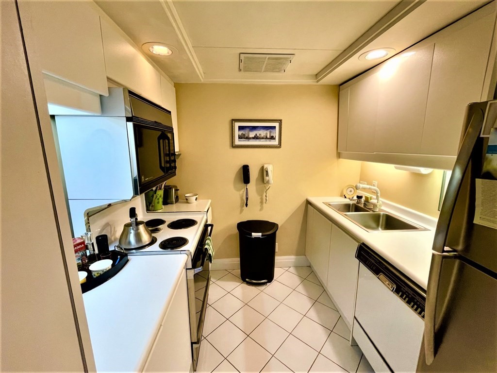 20 Rowes Wharf, Unit 604 Boston, MA 02110 - Photo 6 of 20 a view of a kitchen with fridge and workspace