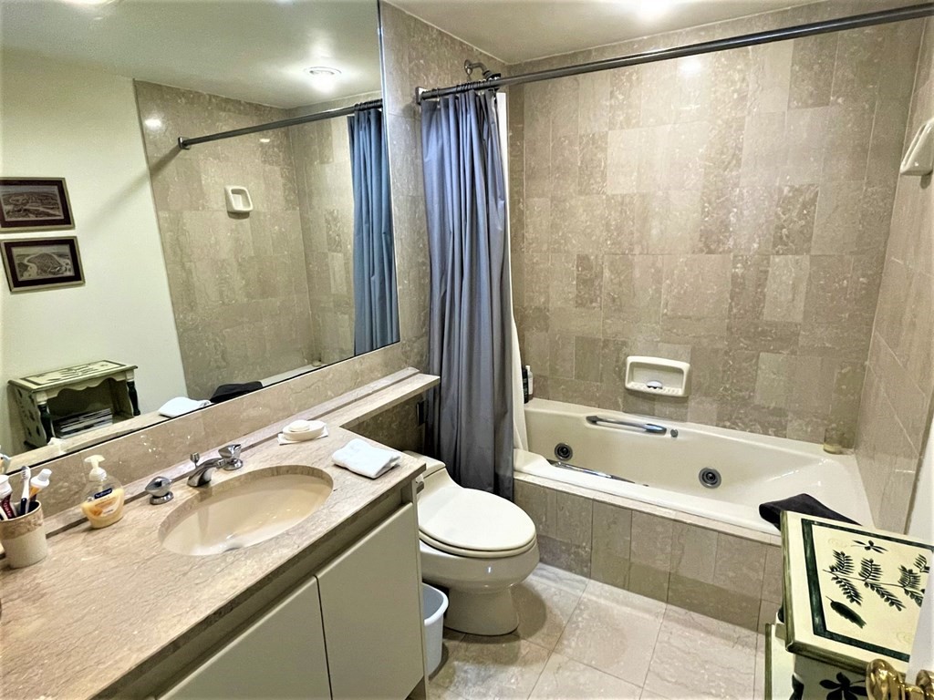 20 Rowes Wharf, Unit 604 Boston, MA 02110 - Photo 10 of 20 a bathroom with a sink mirror toilet and bathtub