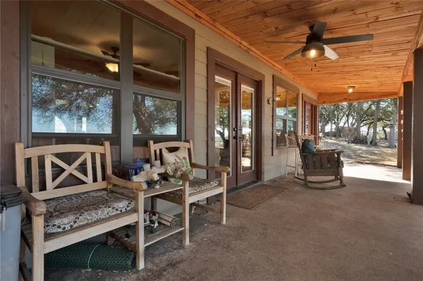 a living room with furniture a floor to ceiling window and a table