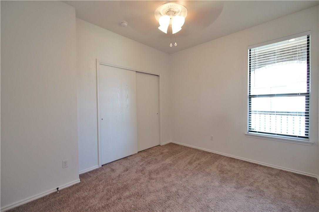 2204 Old Sterling Road Cedar Park, TX 78613 - Photo 11 of 22 an empty room with a chandelier fan and windows