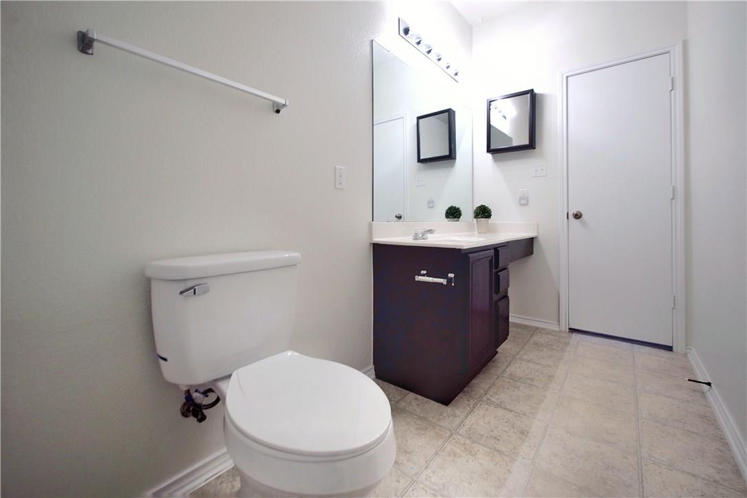 2204 Old Sterling Road Cedar Park, TX 78613 - Photo 14 of 22 a spacious bathroom with a toilet sink and mirror