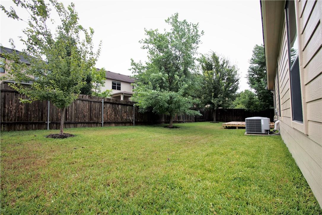 2204 Old Sterling Road Cedar Park, TX 78613 - Photo 17 of 22 a view of a backyard with table and chairs and wooden fence